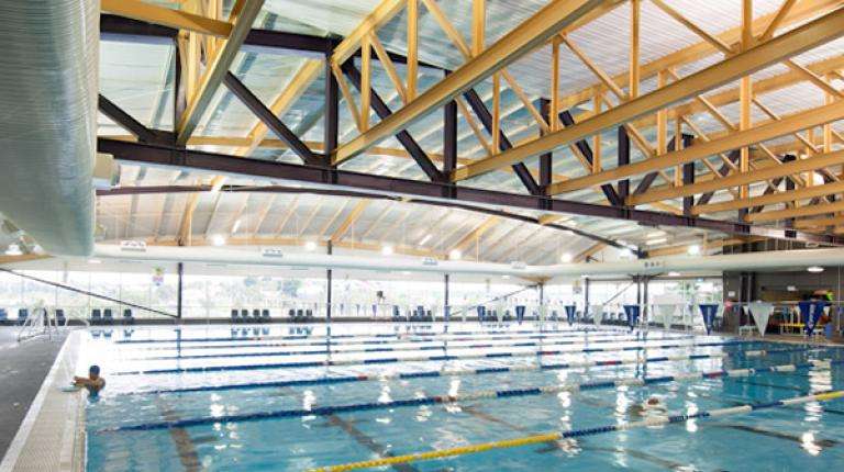 Photo displays big open aquatic centre with views of the multi lane swimming pool
