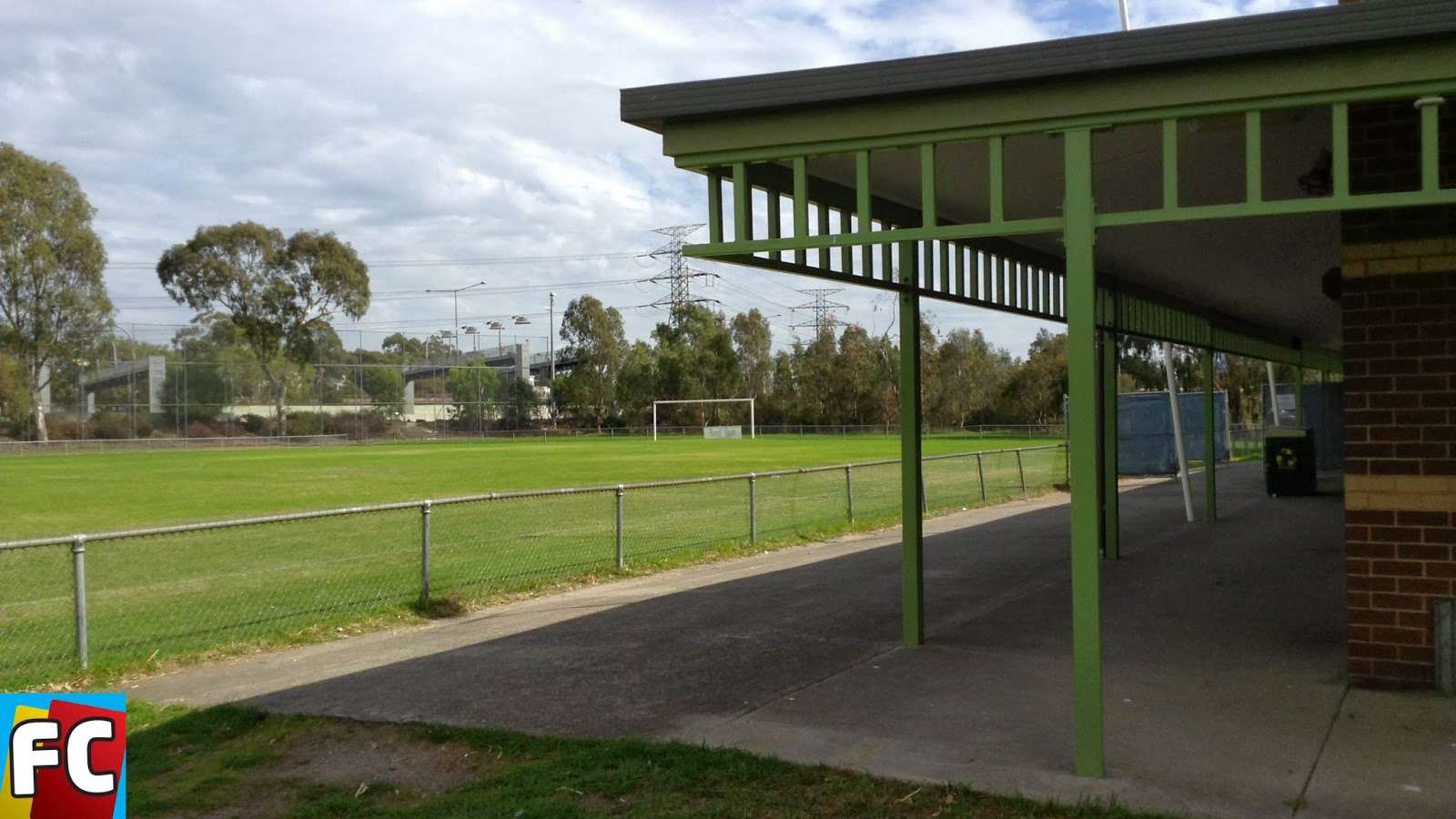 A picture of the pavilion and a green oval at Kevin Bartlett reserve