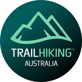 Logo for Trail Hiking Australia featuring stylized green mountains within a circular design, emphasizing outdoor adventure.